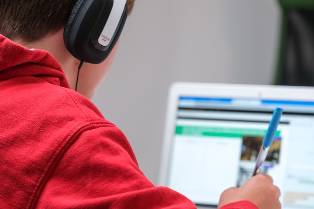 person in red shirt wearing black and gray headphones